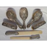A late Victorian silver backed cased dressing table set comprising a hand mirror,