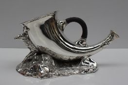 An electroplated nickel silver spoon warmer of horn form mounted on a stag and rocky base,