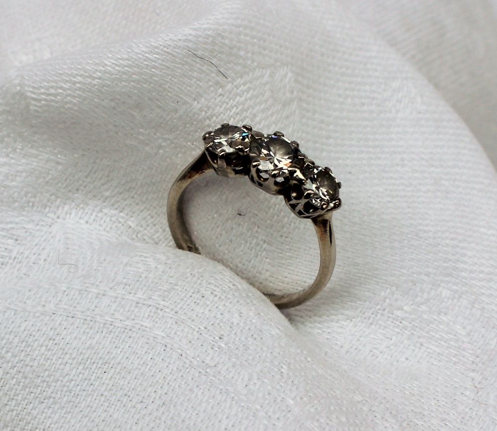 A three stone diamond ring set with a central brilliant cut diamond approximately 0. - Image 4 of 9