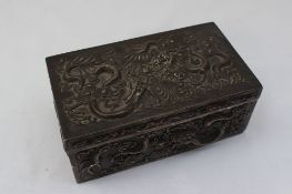 An oriental white metal trinket box of rectangular form decorated with dragons, and clouds,
