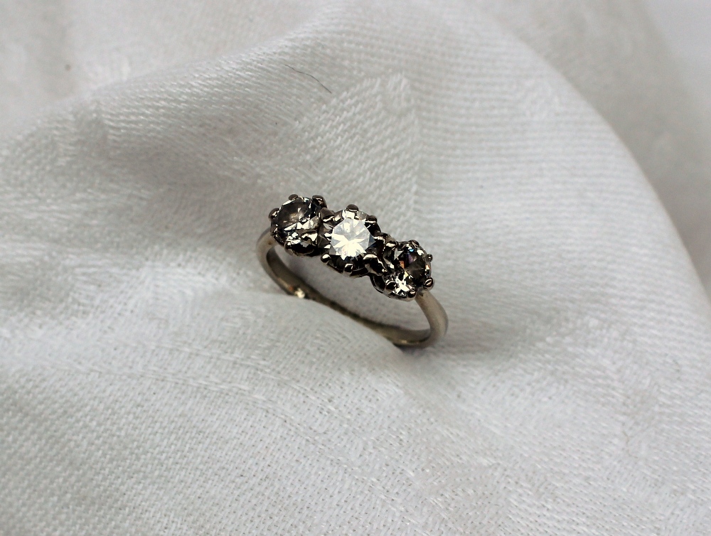 A three stone diamond ring set with a central brilliant cut diamond approximately 0. - Image 3 of 9