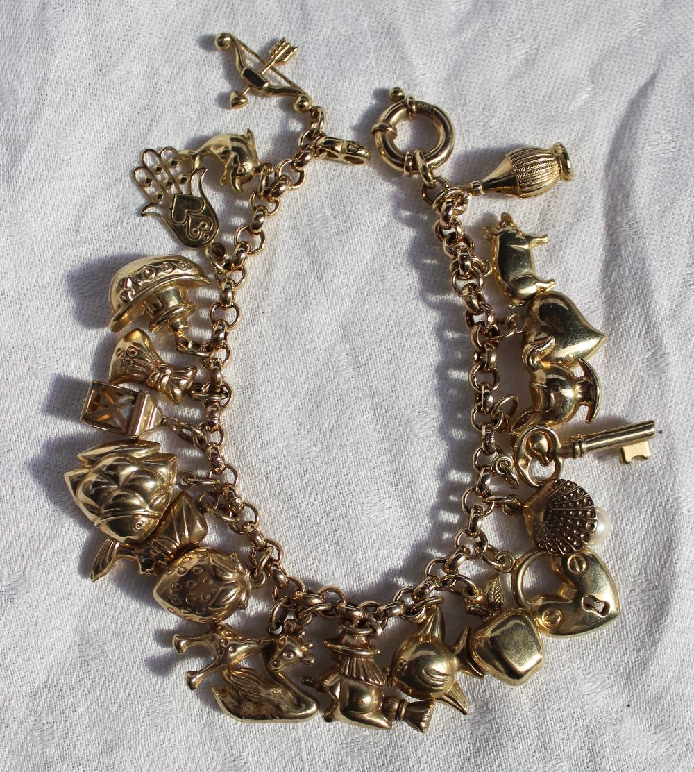 A 9ct yellow gold charm bracelet, set with a dolphin, fish, giraffe, strawberry etc, marked 375, - Image 2 of 3