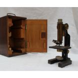 An Emil Busch lacquered brass monocular microscope with an ebonised body No.