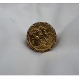 A George V gold sovereign,