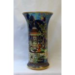 A Carlton Ware Persian pattern flared vase with a blue lustre ground on a gilt foot,