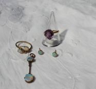 An amethyst set dress ring to a yellow metal setting and shank together with opal pendant,