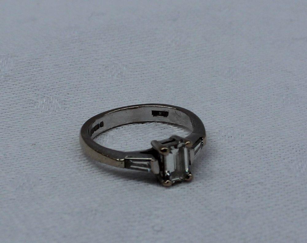 A solitaire diamond ring, the emerald cut diamond measuring 5mm x 4mm x 2mm, - Image 5 of 7