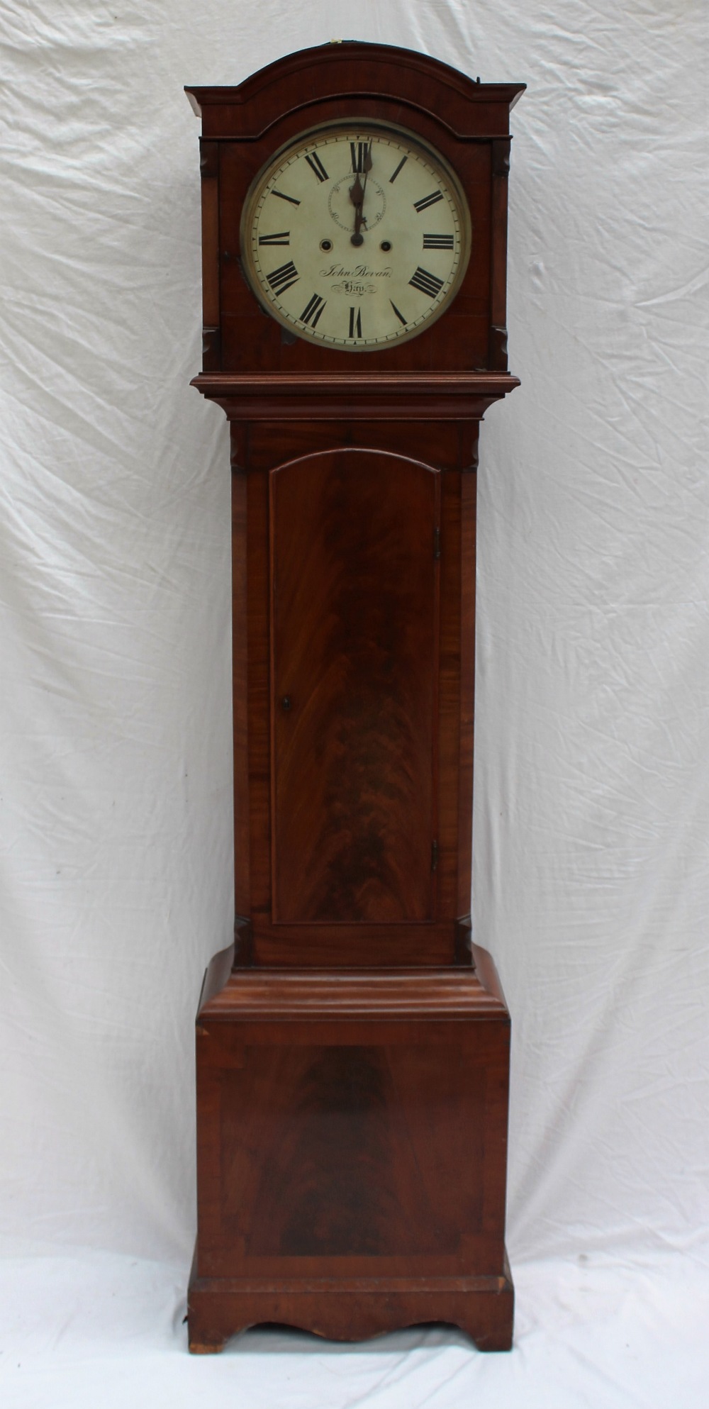 A 19th century mahogany longcase clock, the arched hood above a long trunk door,