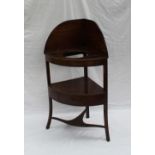 A George III mahogany corner washstand, with a raised back, recesses for wash basin etc,