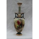 A Hadley's Worcester porcelain twin handled single stem vase, painted with roses to an ivory ground,