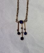 A diamond and blue stone necklace on a yellow metal chain marked 15ct CONDITION REPORT:
