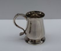 A George II silver tankard, of baluster form on a spreading foot with a scrolling handle, Newcastle,