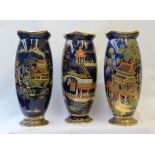 Three Carlton Ware vases decorated with chinoiserie scenes to a mottled blue ground on a spreading