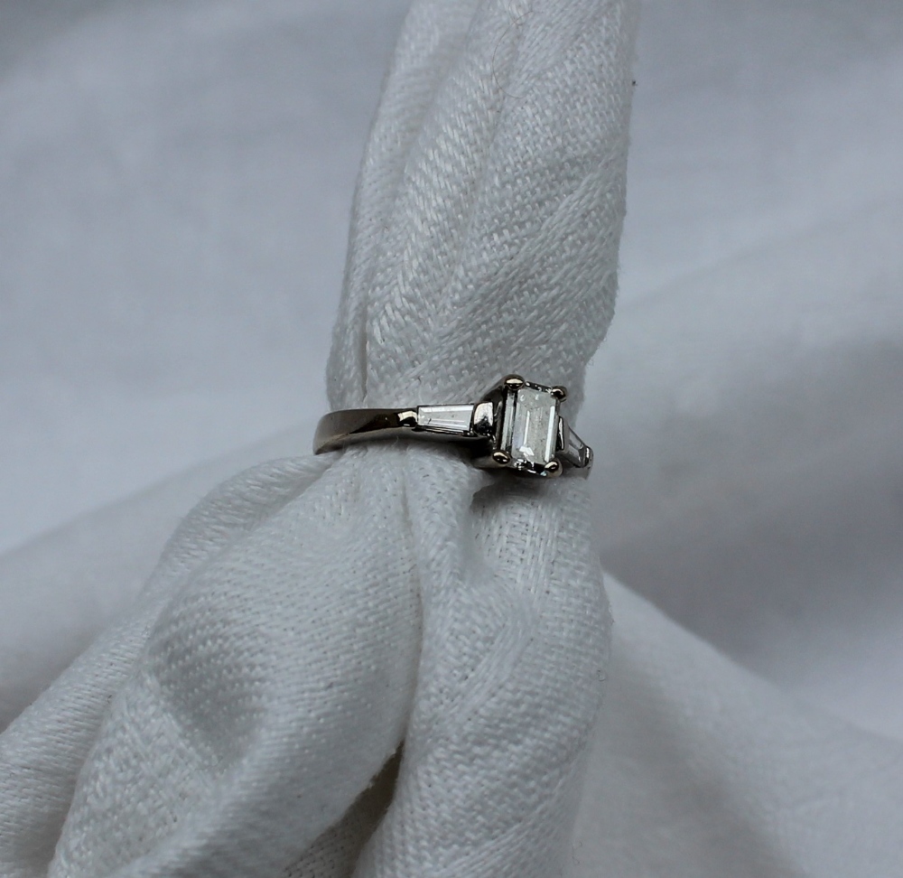 A solitaire diamond ring, the emerald cut diamond measuring 5mm x 4mm x 2mm, - Image 3 of 7