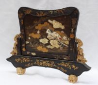 A Japanese shibayama lacquer and hardwood table screen inlaid and mounted with ivory and mother of
