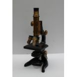 An Ernst Leitz of Wetzler lacquered brass and ebonised monocular microscope with a moveable