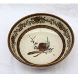 A Japanese Satsuma pottery bowl, decorated with phoenix, flowers and leaves,
