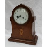 An Edwardian chequer banded oak mantle clock of pointed ogee form with a shell inlay on a plinth