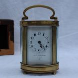 A French brass carriage timepiece, the oval case on flattened bun feet,