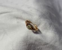 A diamond set signet ring the oval stone claw set in yellow metal to a yellow metal shank