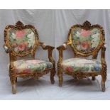 A pair of 19th century continental gilt decorated elbow chairs with a carved C scrolling back,