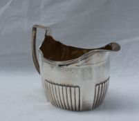 A late George III silver cream jug of oval panelled shape with a half reeded base, London, 1805,