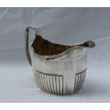 A late George III silver cream jug of oval panelled shape with a half reeded base, London, 1805,