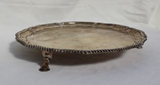 A George V silver salver with a shaped and gadrooned edge on three hoof feet, Sheffield, 1911,