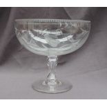 A 19th century glass pedestal bowl engraved with leaves and fruit on a waisted stem and a spreading