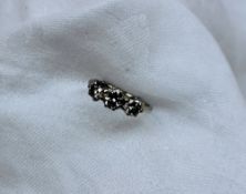 A three stone diamond ring set with a central brilliant cut diamond approximately 0.