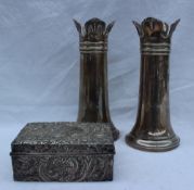 A pair of George V silver vases with a shaped top and tapering cylindrical column on a spreading