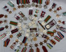 A collection of World War II medals, including Defence medals, British War medals, 1939-1945 stars,
