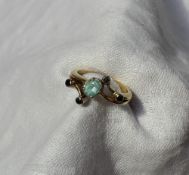 A 14 carat gold paraiba tourmaline and black diamond dress ring