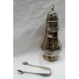 A late Victorian silver sugar caster with a panelled domed top and finial above a baluster panelled
