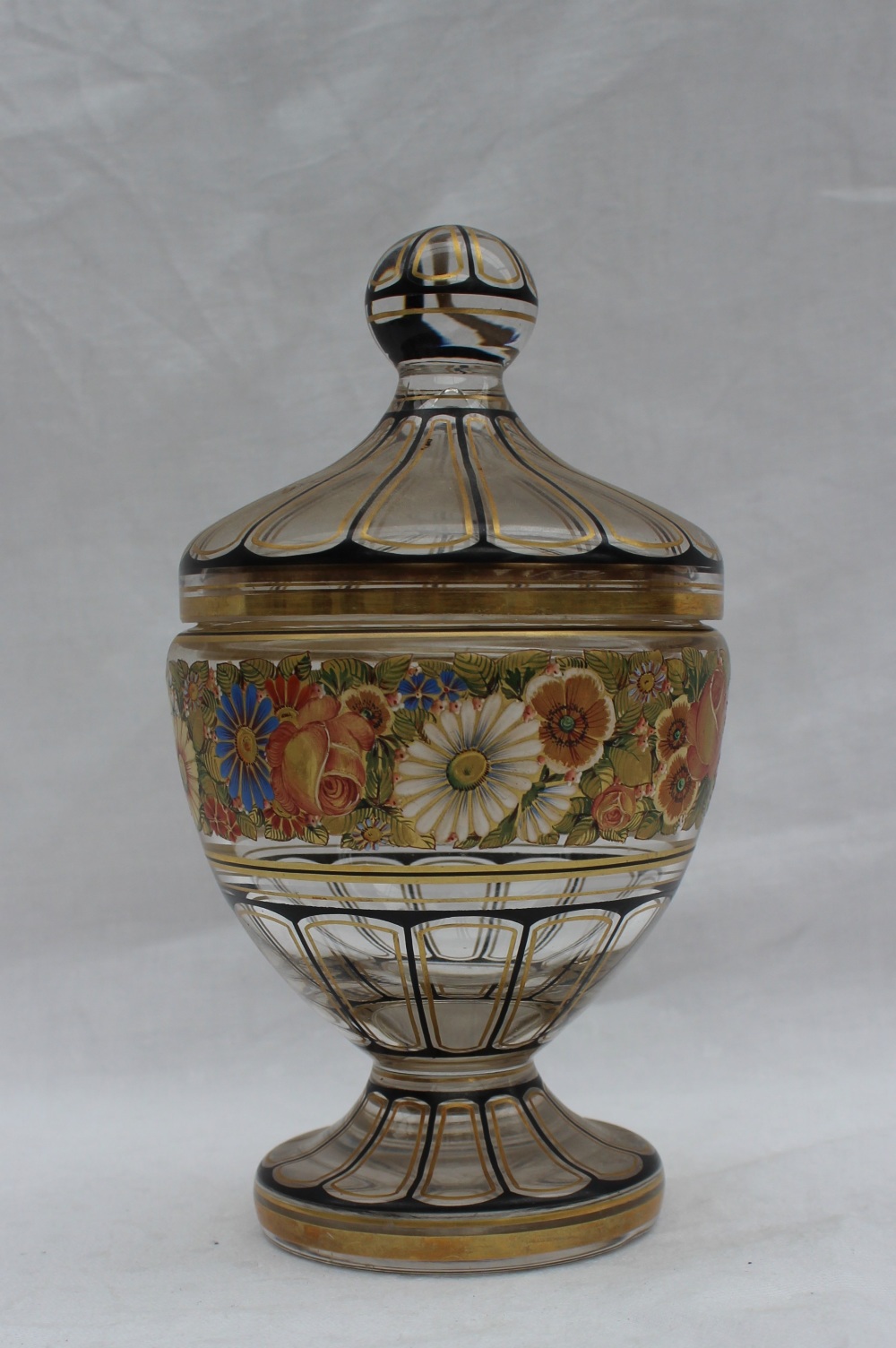 A 19th century glass vase and cover with gilt highlighted panels,