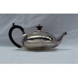 An Edward VII silver teapot of squat form with an ebonised handle, Chester, 1908,
