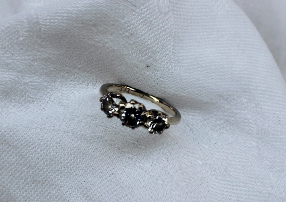 A three stone diamond ring set with a central brilliant cut diamond approximately 0. - Image 2 of 9