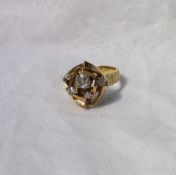 An 18ct yellow gold dress ring set with five old cut diamonds in a geometric pattern on a textured