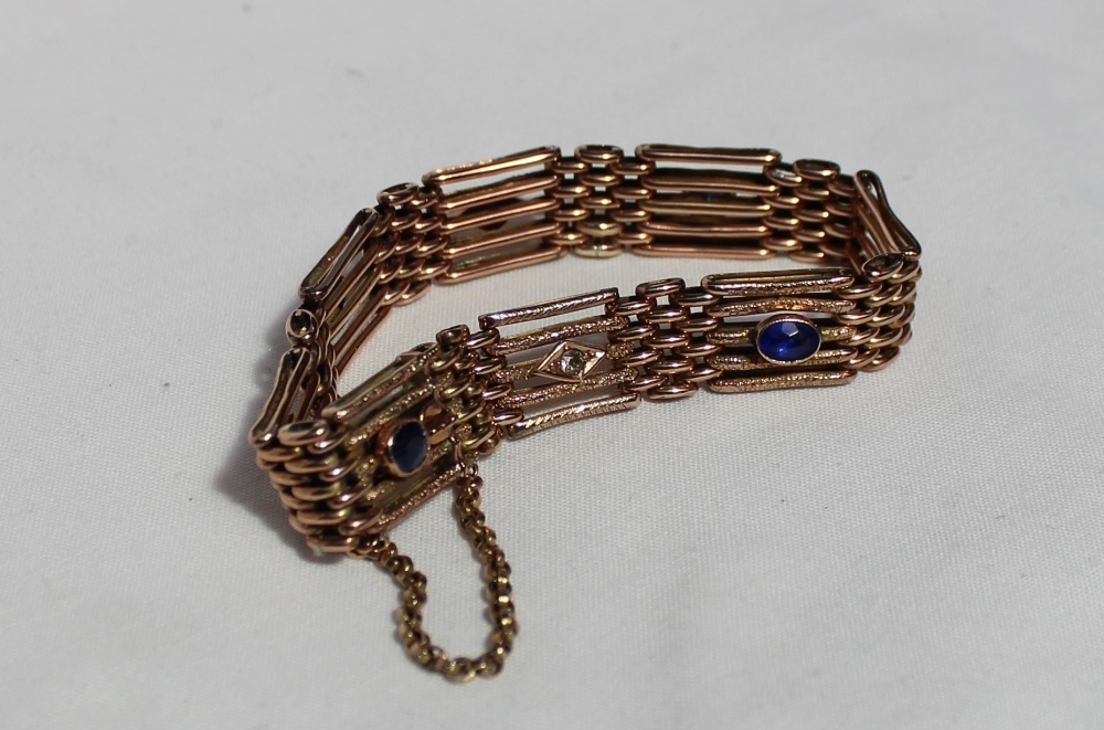 A yellow metal five bar gate bracelet set with sapphire, diamond and paste stones,
