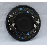 A black slate circular stand inlaid with hardstones in the form of flower heads and leaves, 20.
