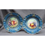 A pair of Royal Worcester bowls of shaped circular form with a gilt border,