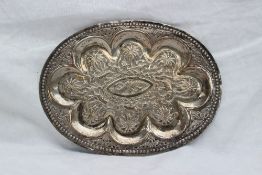 An Anglo Indian white metal dish of oval form, embossed with fish, animals and trees, 19.
