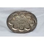 An Anglo Indian white metal dish of oval form, embossed with fish, animals and trees, 19.