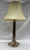 A silver table lamp with an octagonal column on a square base