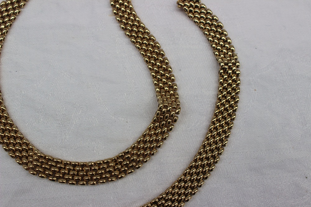 A yellow gold necklace and matching bracelet, with five rows of oval links,