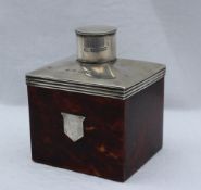 A late Victorian silver and tortoiseshell tea caddy, of rectangular form with a cylindrical cover,