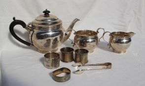 A George V silver three piece silver teaset, London, 1925 together with silver napkin rings,