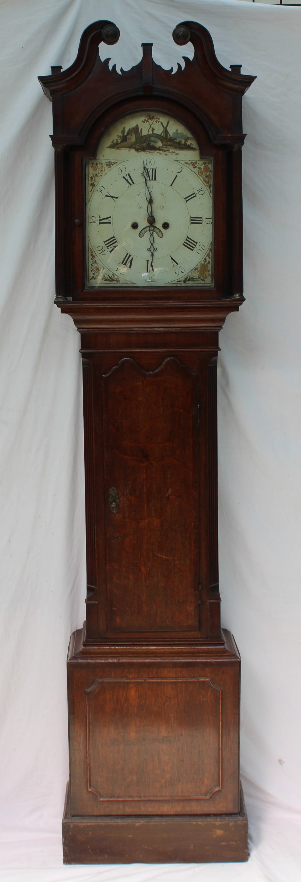 A 19th century oak longcase clock, the hood with a broken swan neck pediment and fluted columns,