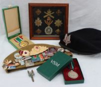 A Kingdom of Saudi Arabia medal cased together with a silver Voluntary service medal,