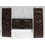 A pair of 18th century carved oak panels, depicting scrolls and portrait heads, 17 x 50.